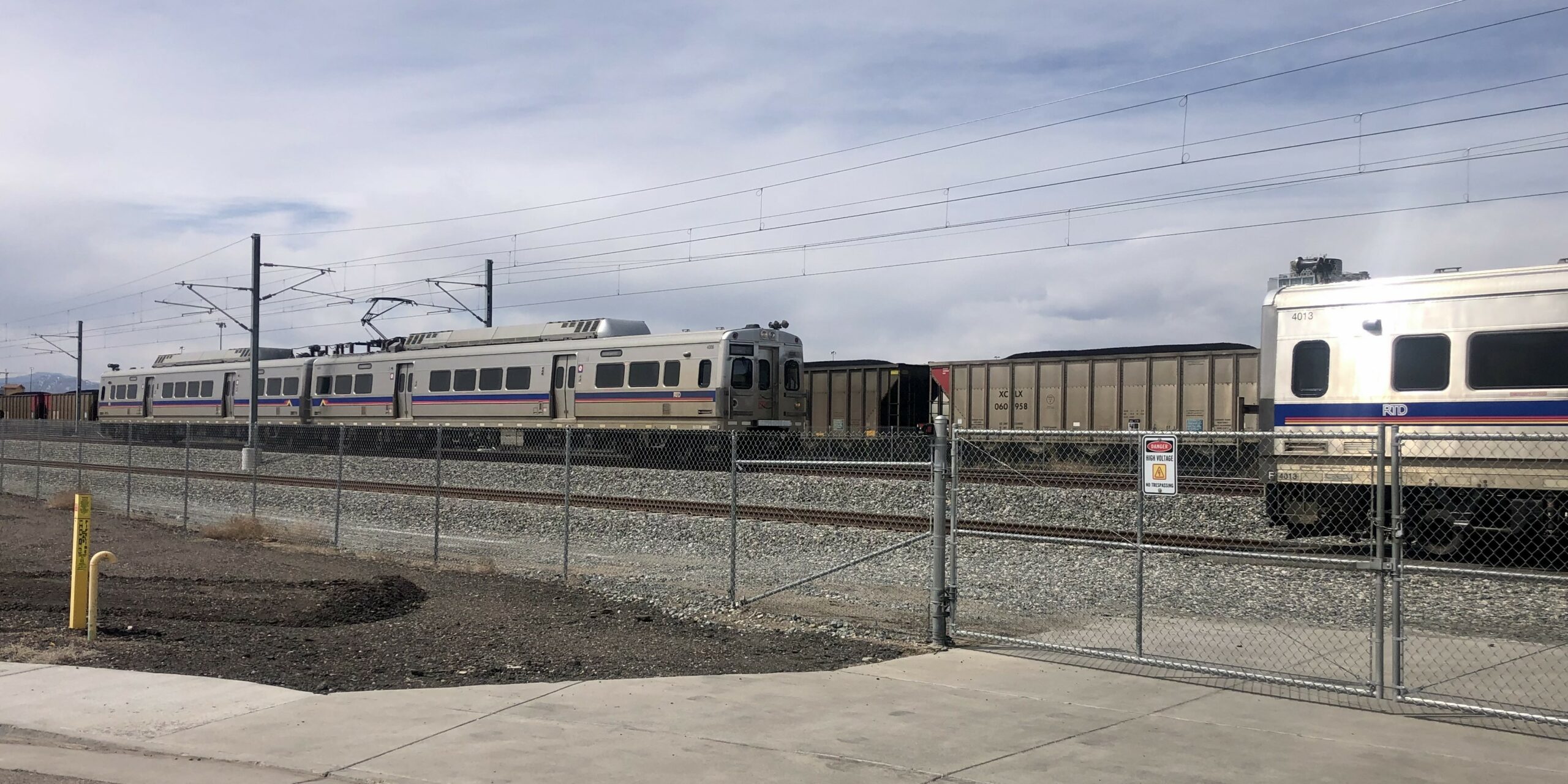 An N Line train passes the spare unit at the 31st St siding.