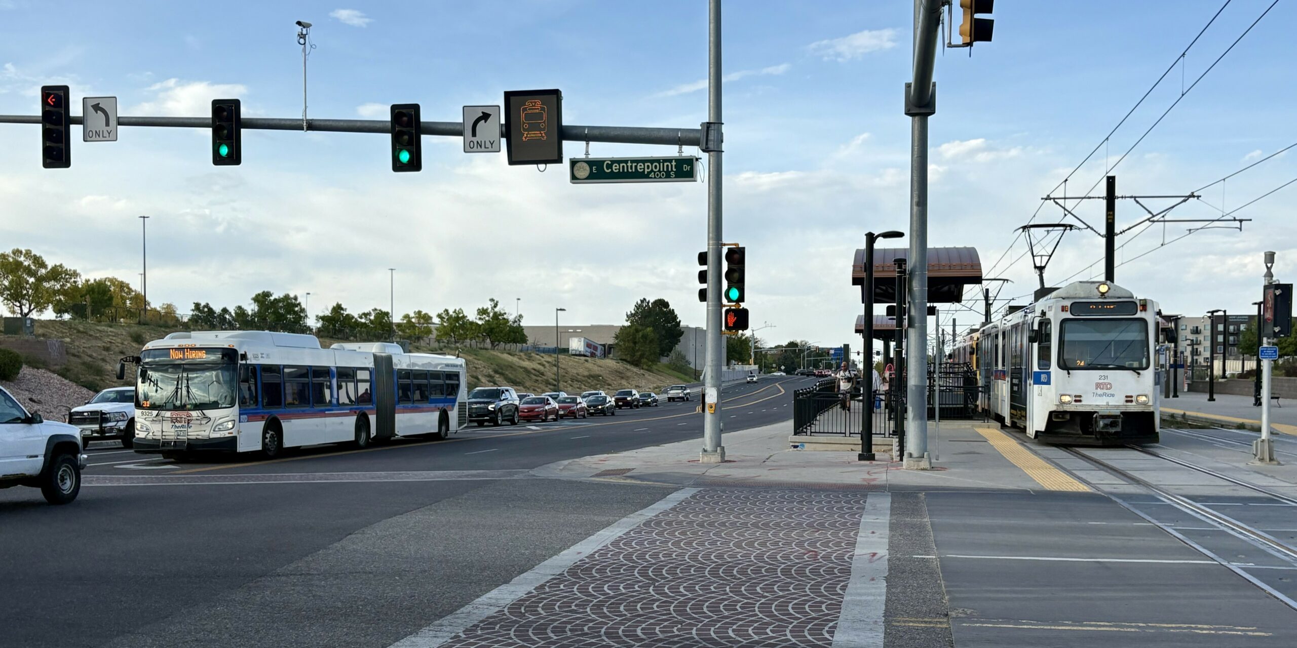 R Line train and 15L bus at Aurora Metro Center.