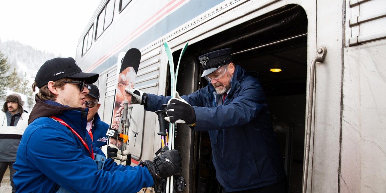 The train hosts help load skis and snowboards into a dedicated storage area on board.